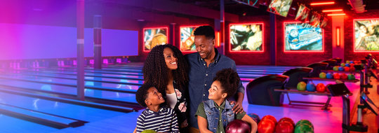 Family of four enjoying bowling together