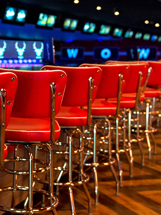 Red barstools and lanes