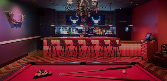 Red billiards tables and a bar