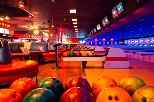 bowling lanes and bowling balls with neon lighting