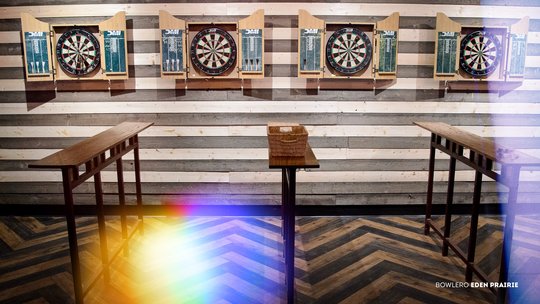dart boards on a striped wall