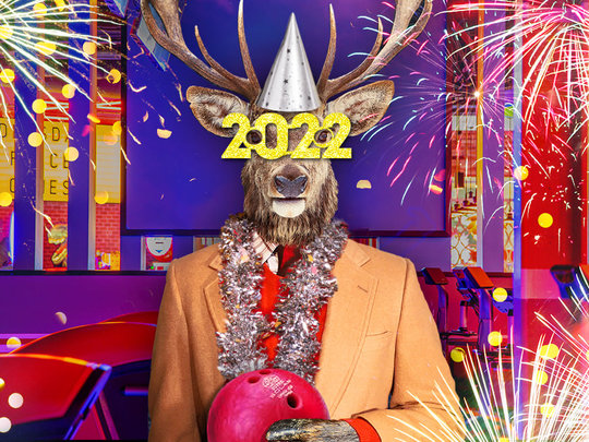 elk with 2022 glasses holding a bowling ball